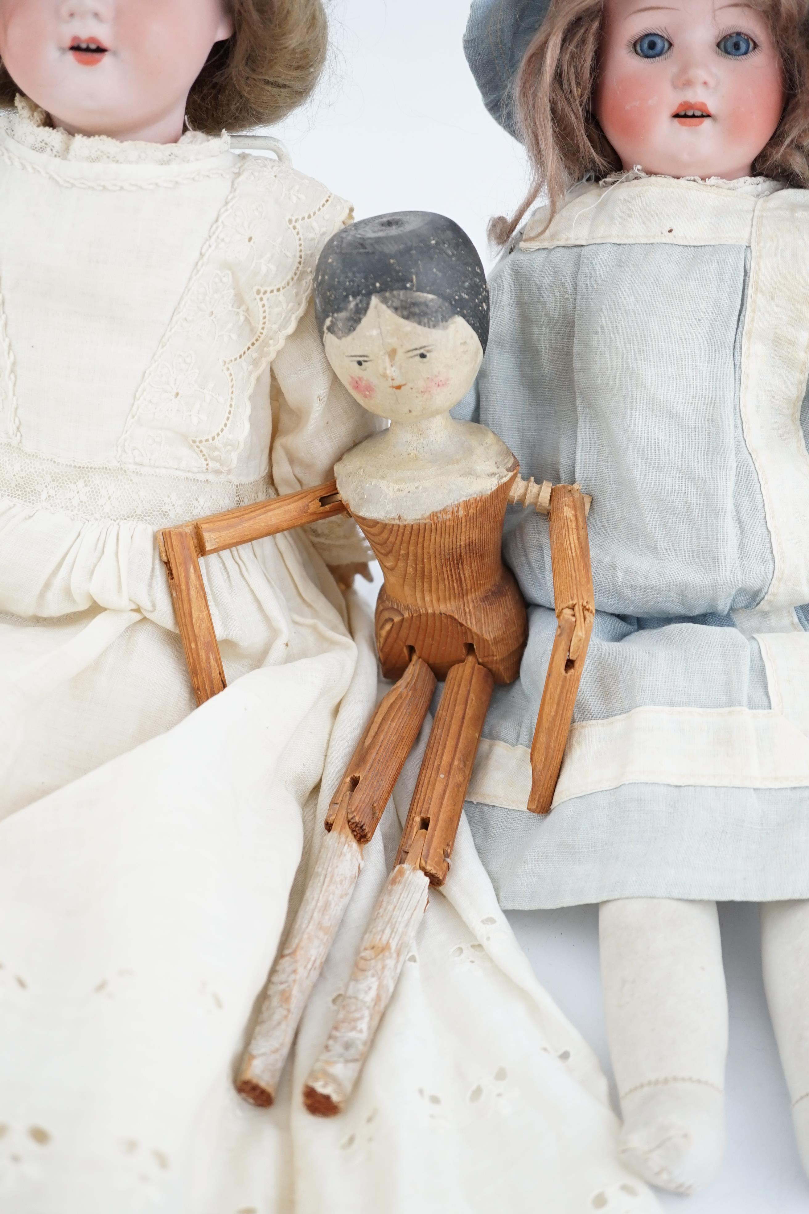 An AM390, 46cm, a Heubach shoulder plate, 34cm, together with wooden doll, 30cm